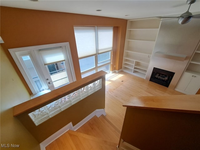 12595 Larchmere Blvd Unit E6, Cleveland, OH 44120 - unfurnished living room featuring wood finished floors, a large fireplace, built in features, and ceiling fan