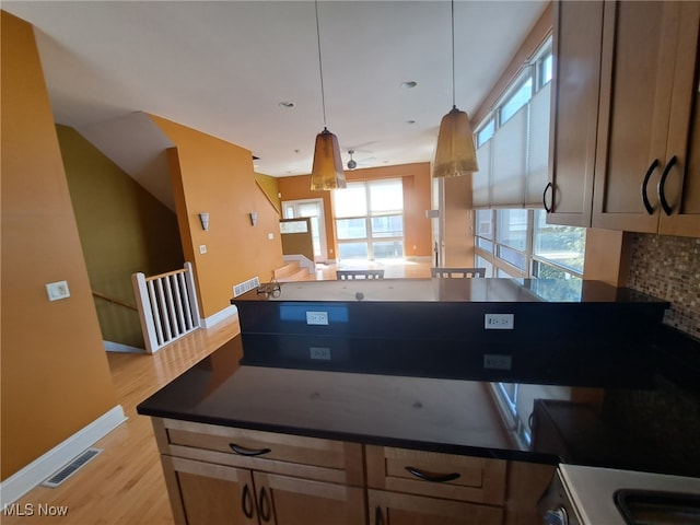 12595 Larchmere Blvd Unit E6, Cleveland, OH 44120 - kitchen with light wood finished floors, pendant lighting, a peninsula, and dark countertops