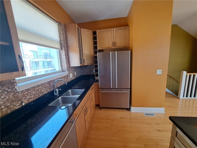 12595 Larchmere Blvd Unit E6, Cleveland, OH 44120 - kitchen with freestanding refrigerator, decorative backsplash, light wood-style floors, and dark countertops