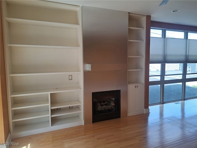 12595 Larchmere Blvd Unit E6, Cleveland, OH 44120 - unfurnished living room with light wood-style flooring, a fireplace, and built in shelves