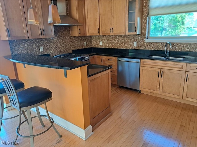 12595 Larchmere Blvd Unit E6, Cleveland, OH 44120 - kitchen with appliances with stainless steel finishes, wall chimney range hood, light wood-style floors, and a kitchen breakfast bar