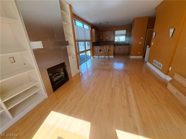12595 Larchmere Blvd Unit E6, Cleveland, OH 44120 - unfurnished living room featuring light wood-style floors and a large fireplace