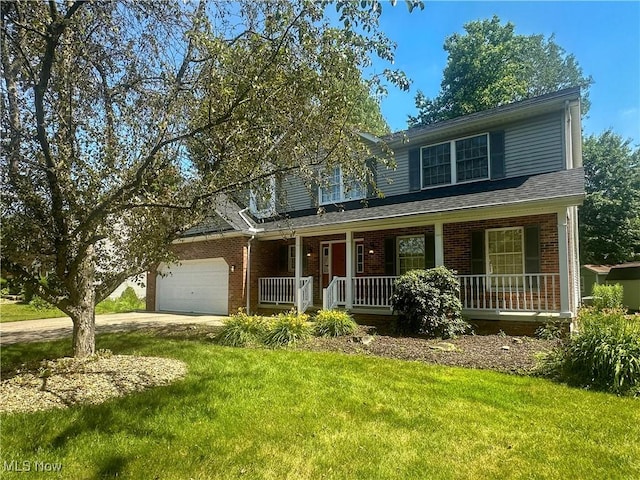 132 Beechwood Dr, Cortland, OH 44410 - traditional-style house with a porch, brick siding, an attached garage, and a front yard