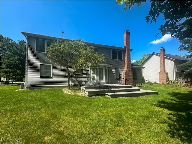 132 Beechwood Dr, Cortland, OH 44410 - back of property with a yard, a wooden deck, and a chimney