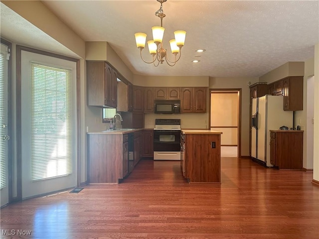 132 Beechwood Dr, Cortland, OH 44410 - kitchen with white appliances, dark wood-style flooring, a chandelier, light countertops, and recessed lighting