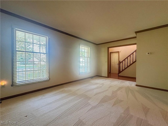 132 Beechwood Dr, Cortland, OH 44410 - empty room with light colored carpet, ornamental molding, and stairs
