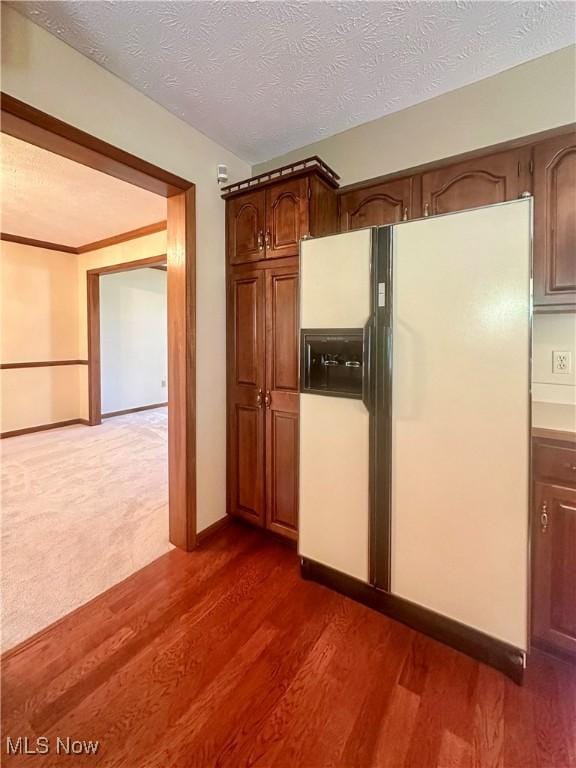 132 Beechwood Dr, Cortland, OH 44410 - kitchen featuring white fridge with ice dispenser, dark wood-type flooring, and a textured ceiling