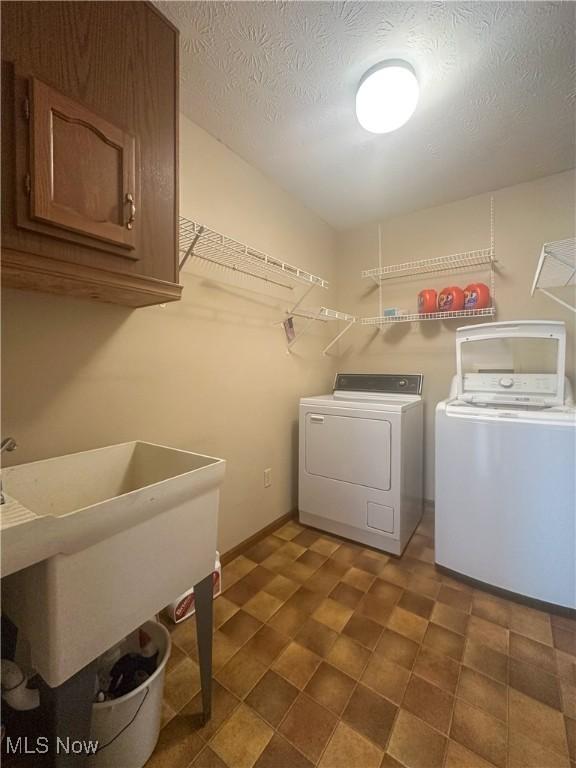 132 Beechwood Dr, Cortland, OH 44410 - laundry room featuring cabinet space and washing machine and dryer