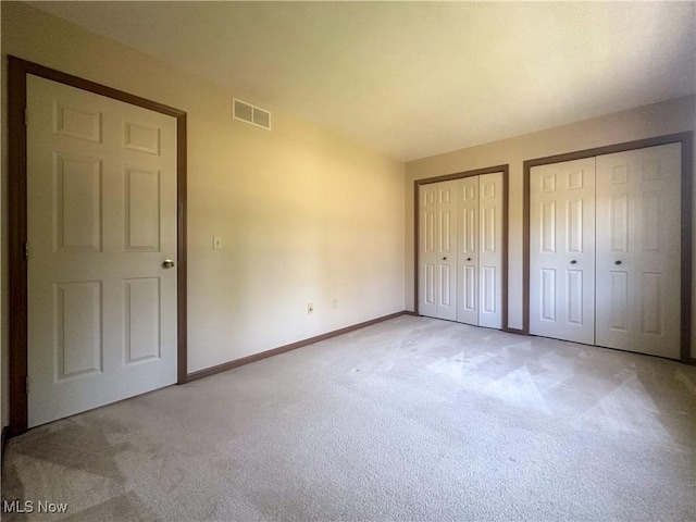 132 Beechwood Dr, Cortland, OH 44410 - unfurnished bedroom with light carpet and two closets
