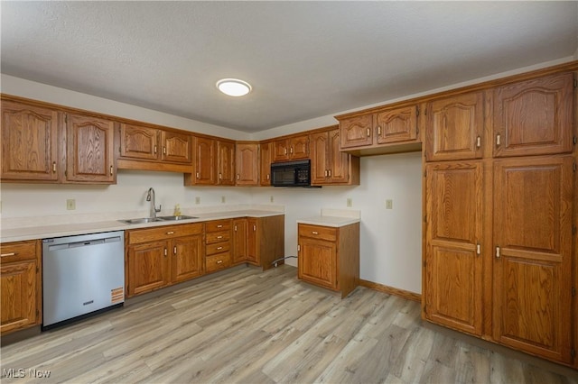 596 Glenmere Pl, Barberton, OH 44203 - kitchen featuring stainless steel dishwasher, black microwave, brown cabinets, and light wood-style floors