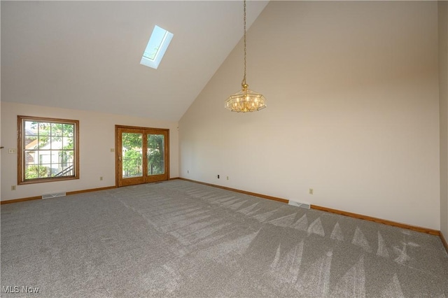 596 Glenmere Pl, Barberton, OH 44203 - unfurnished room with a skylight, high vaulted ceiling, carpet flooring, and a chandelier