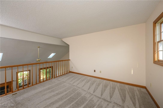 596 Glenmere Pl, Barberton, OH 44203 - carpeted empty room with ceiling fan, plenty of natural light, a textured ceiling, and a skylight