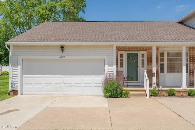 6706 Hogan Way NW, Canton, OH 44718 - view of front facade featuring driveway, roof with shingles, brick siding, and an attached garage