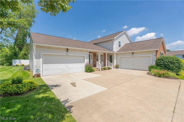 6706 Hogan Way NW, Canton, OH 44718 - traditional-style home featuring a garage, driveway, a front yard, and a porch