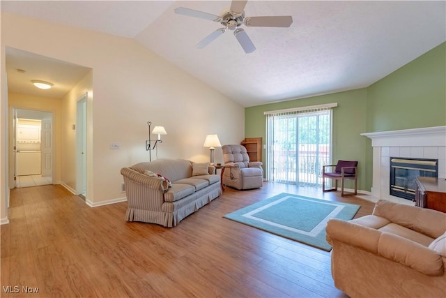 6706 Hogan Way NW, Canton, OH 44718 - living area featuring lofted ceiling, wood finished floors, a ceiling fan, and a tile fireplace