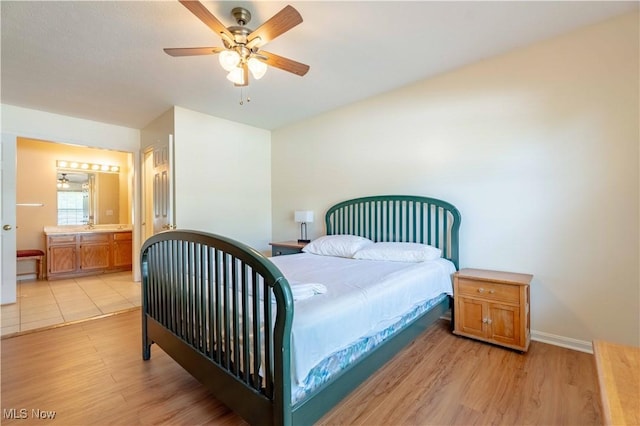 6706 Hogan Way NW, Canton, OH 44718 - bedroom featuring light wood-style flooring, a ceiling fan, and connected bathroom