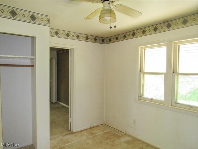 12316 Sunset Dr, Garfield Heights, OH 44125 - unfurnished bedroom featuring ceiling fan