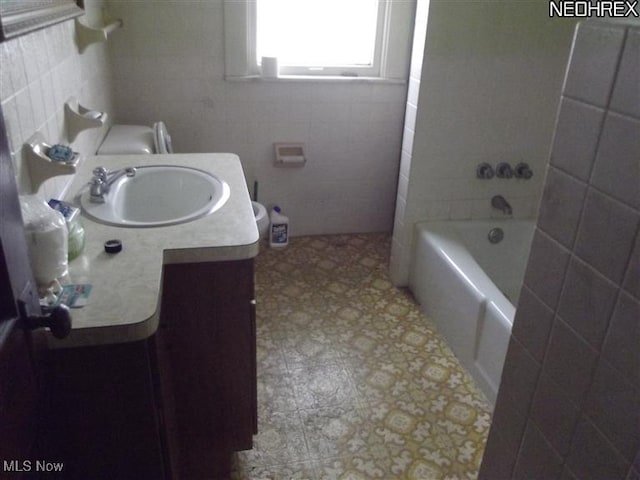 5257 Philip St, Maple Heights, OH 44137 - bathroom featuring vanity, tile walls, and shower / bathtub combination