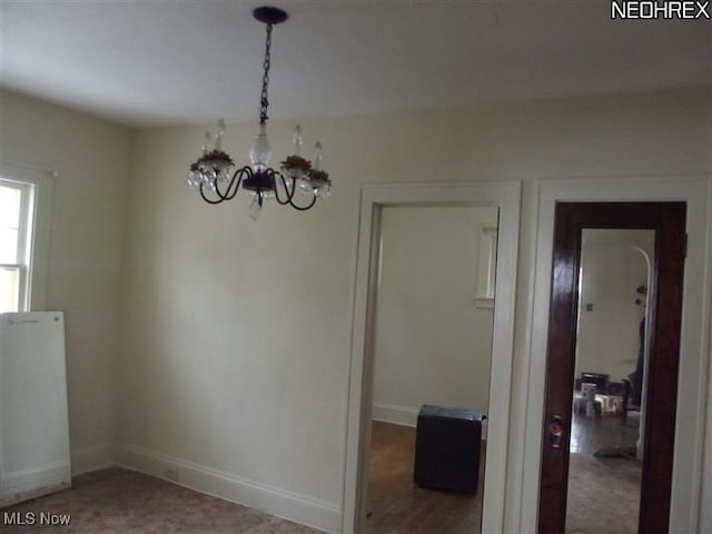 5257 Philip St, Maple Heights, OH 44137 - unfurnished dining area with a chandelier and baseboards