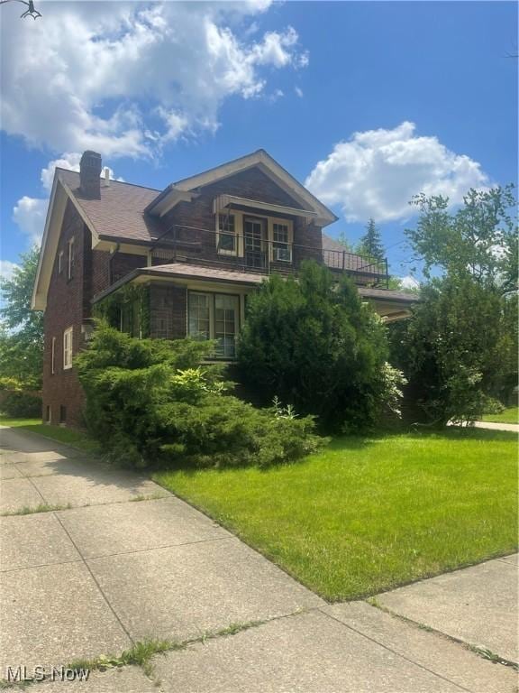 5257 Philip St, Maple Heights, OH 44137 - view of property exterior featuring a balcony, a chimney, and a lawn