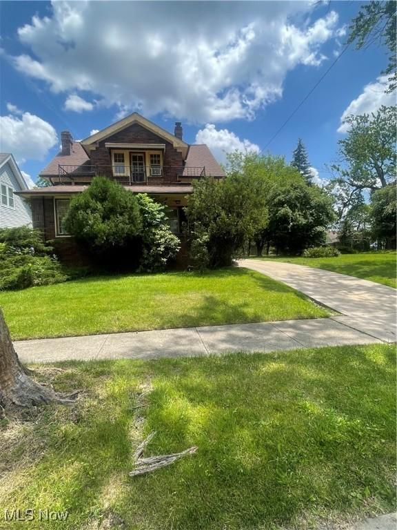 5257 Philip St, Maple Heights, OH 44137 - view of front facade with a front lawn and a chimney