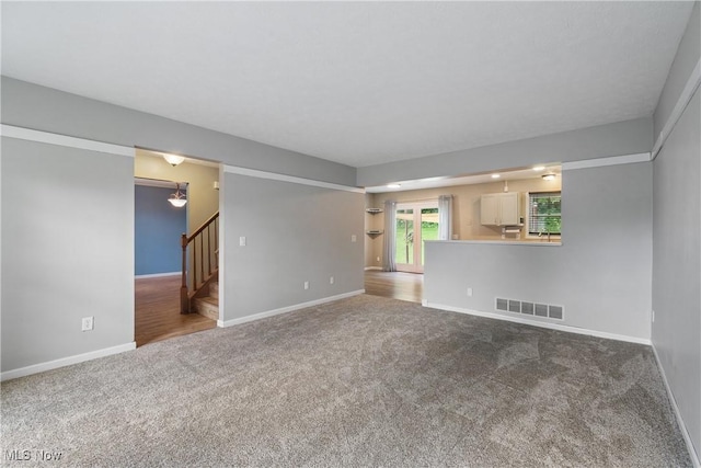 448 Derbyshire Rd, Akron, OH 44319 - unfurnished living room with carpet and stairs