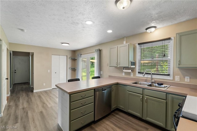 448 Derbyshire Rd, Akron, OH 44319 - kitchen with stainless steel dishwasher, a peninsula, a textured ceiling, stove, and wood finished floors
