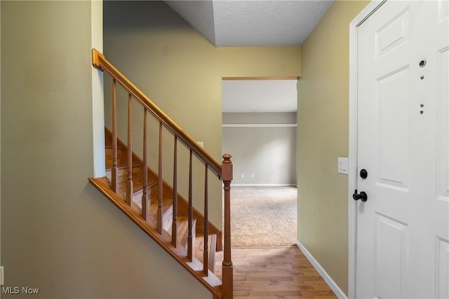 448 Derbyshire Rd, Akron, OH 44319 - entrance foyer with a textured ceiling, wood finished floors, and stairway