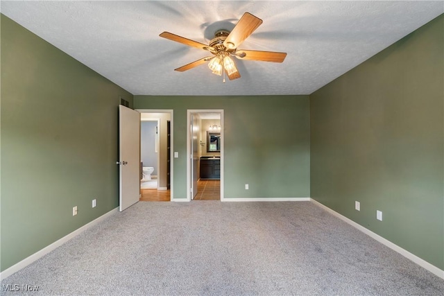448 Derbyshire Rd, Akron, OH 44319 - unfurnished bedroom with connected bathroom, carpet floors, and ceiling fan