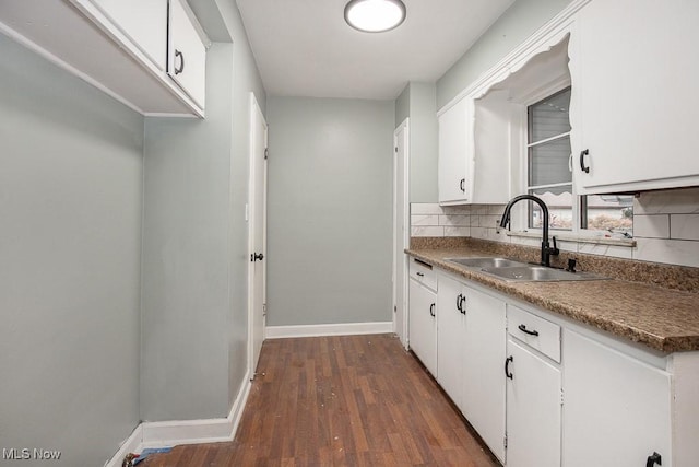 11202 Mountview Ave, Garfield Heights, OH 44125 - kitchen with dark wood-style floors, white cabinetry, and tasteful backsplash