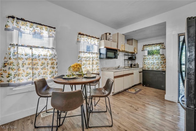 10602 Orville Ave, Cleveland, OH 44106 - dining space with light wood-style flooring and baseboards