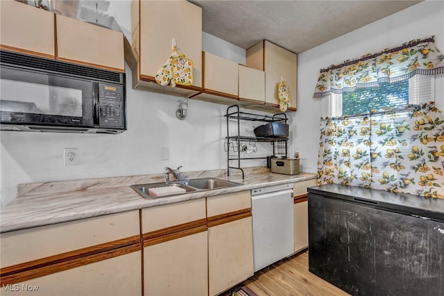 10602 Orville Ave, Cleveland, OH 44106 - kitchen with dishwasher, black microwave, light countertops, and light wood finished floors