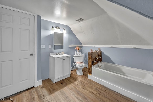 10602 Orville Ave, Cleveland, OH 44106 - bathroom with vanity, a garden tub, wood finished floors, and vaulted ceiling