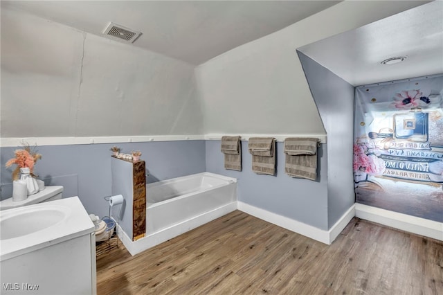 10602 Orville Ave, Cleveland, OH 44106 - bathroom featuring wood finished floors, a garden tub, and vanity