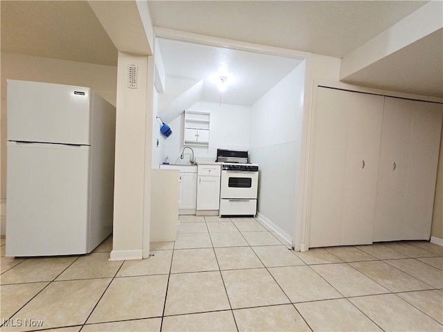 6466 Concord Dr Unit M1, Parma, OH 44134 - kitchen featuring white appliances, white cabinets, light tile patterned floors, light countertops, and lofted ceiling