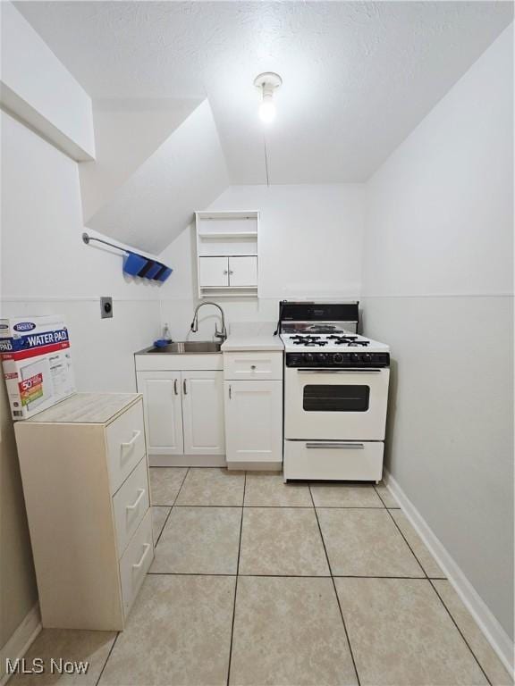 6466 Concord Dr Unit M1, Parma, OH 44134 - kitchen featuring gas range gas stove, white cabinets, open shelves, light countertops, and light tile patterned floors