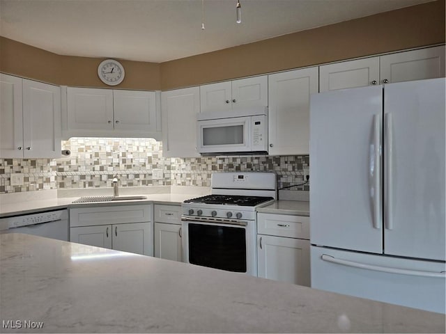 6466 Concord Dr Unit M1, Parma, OH 44134 - kitchen with white appliances, white cabinets, and tasteful backsplash