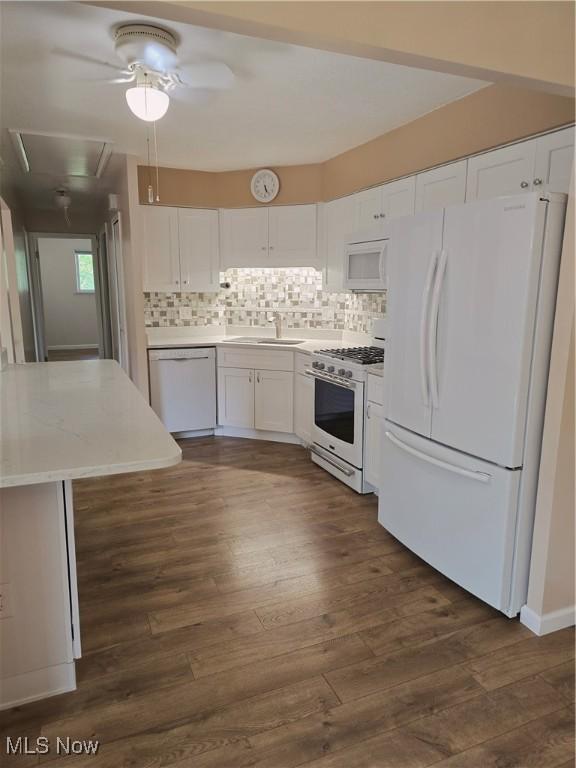 6466 Concord Dr Unit M1, Parma, OH 44134 - kitchen with white appliances, white cabinetry, light countertops, dark wood finished floors, and backsplash