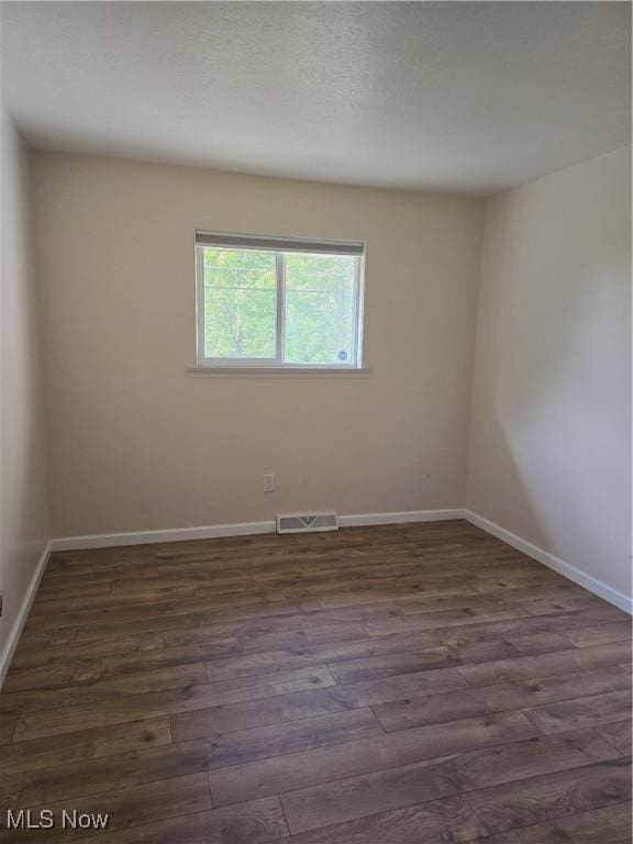 6466 Concord Dr Unit M1, Parma, OH 44134 - unfurnished room featuring dark wood-style floors and baseboards