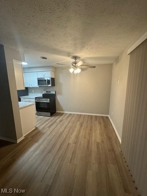 4360 Inner Circle Dr Unit C15, Brunswick, OH 44212 - unfurnished living room with ceiling fan, wood finished floors, and a textured ceiling