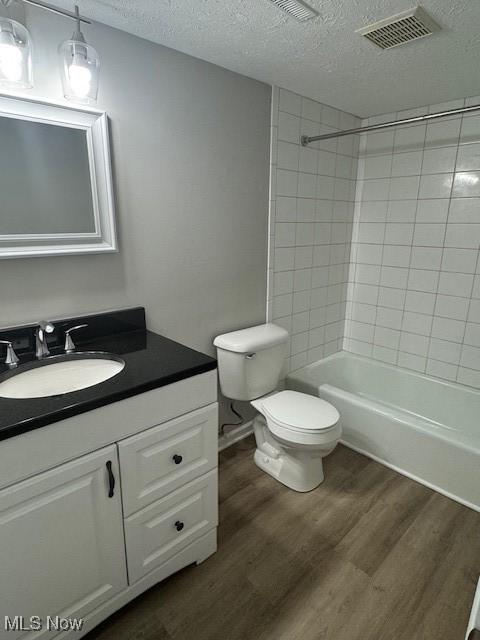 4360 Inner Circle Dr Unit C15, Brunswick, OH 44212 - full bathroom featuring a textured ceiling, vanity, wood finished floors, and shower / tub combination