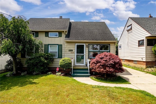 12610 Woodward Blvd, Garfield Heights, OH 44125 - view of front facade featuring a front lawn, board and batten siding, and a shingled roof