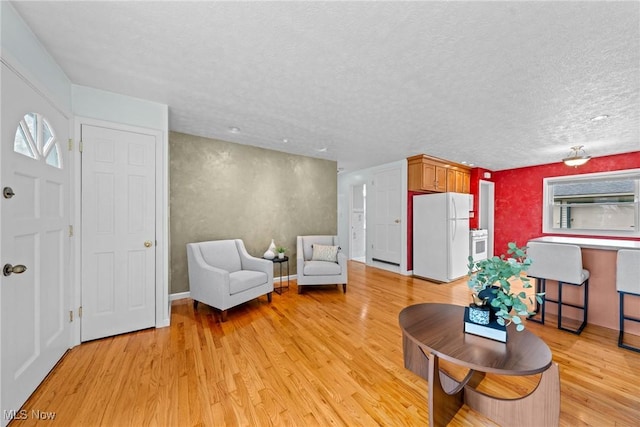 12610 Woodward Blvd, Garfield Heights, OH 44125 - living area featuring light wood-style floors and a textured ceiling