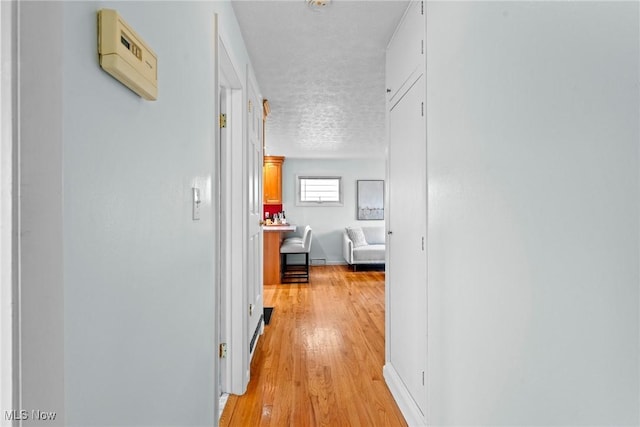 12610 Woodward Blvd, Garfield Heights, OH 44125 - hallway with a textured ceiling and light wood finished floors