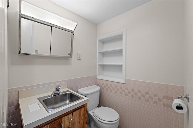 12610 Woodward Blvd, Garfield Heights, OH 44125 - half bath with tile walls, vanity, and wainscoting
