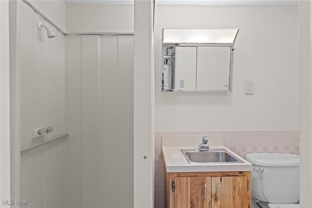 12610 Woodward Blvd, Garfield Heights, OH 44125 - bathroom with vanity, wainscoting, and tile walls