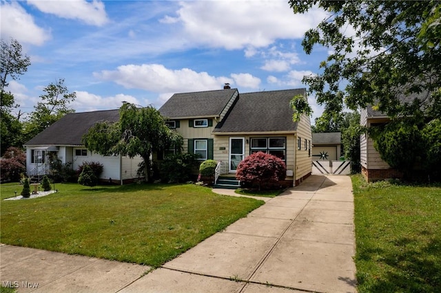 12610 Woodward Blvd, Garfield Heights, OH 44125 - view of front of home featuring a front lawn, a chimney, a garage, and a shingled roof