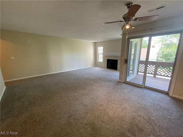 1304 Cedarwood Dr Unit D2, Westlake, OH 44145 - unfurnished living room with carpet flooring, ceiling fan, a textured ceiling, and a fireplace