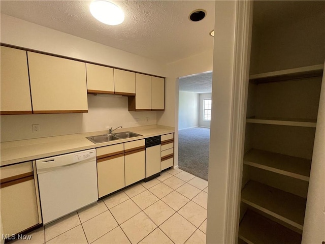 1304 Cedarwood Dr Unit D2, Westlake, OH 44145 - kitchen featuring white dishwasher, a textured ceiling, light countertops, light carpet, and light tile patterned flooring