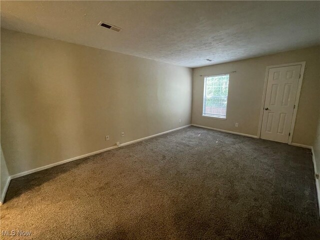 1304 Cedarwood Dr Unit D2, Westlake, OH 44145 - empty room featuring carpet flooring and a textured ceiling